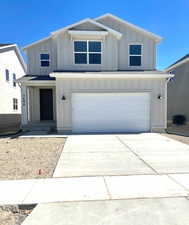 View of front of house featuring board and batten siding, a garage, driveway, and central air condition unit
