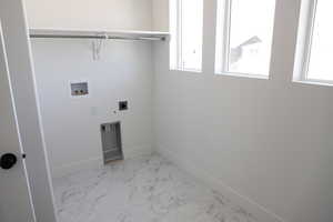 Washroom featuring hookup for a washing machine, electric dryer hookup, baseboards, and marble finish flooring