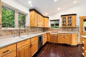 Corian Counters, New Lighting, Skylights, Tile Backsplash, Wood Flooring, Custom Cabinets, Island with Prep Sink