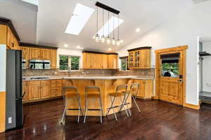 Corian Counters, New Lighting, Skylights, Tile Backsplash, Wood Flooring, Custom Cabinets, Island with Prep Sink