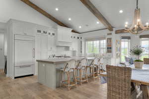 Kitchen featuring a chandelier, decorative backsplash, light wood-style flooring, healthy amount of natural light, and recessed lighting