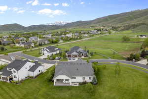 Aerial perspective of suburban area featuring a mountainous background
