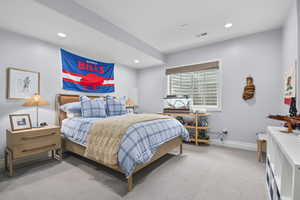 Carpeted bedroom with recessed lighting and baseboards