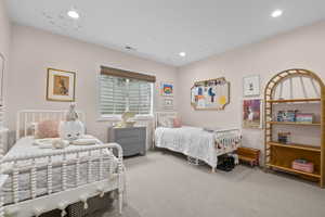 Carpeted bedroom with recessed lighting