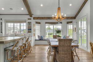 Dining room featuring light wood finished floors, a chandelier, recessed lighting, crown molding, and baseboards