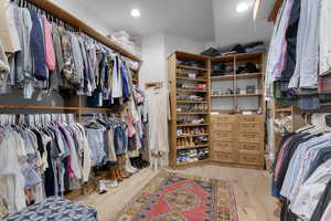 Walk in closet featuring wood finished floors