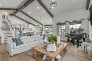 Living room with a chandelier, light wood-type flooring, recessed lighting, stairway, and wood ceiling