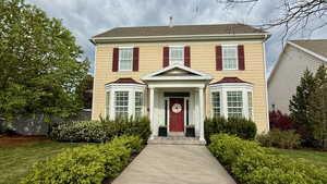 View of front of property featuring a shingled roof and a standing seam roof