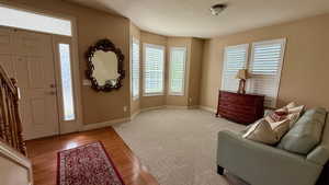 Entryway featuring a textured ceiling, light wood-type flooring, and baseboards
