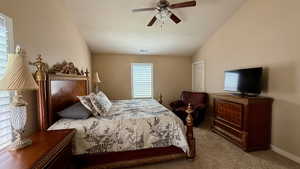 Carpeted bedroom featuring a textured ceiling, a ceiling fan, and baseboards