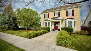 View of front of property featuring a front yard and roof with shingles