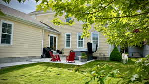 View of grassy yard featuring a patio