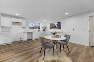 Dining room featuring wood finished floors, recessed lighting, and baseboards