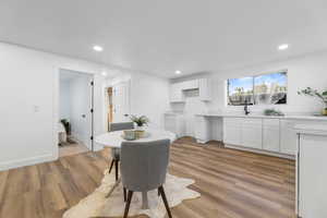Dining room featuring light wood-style floors, recessed lighting, and baseboards