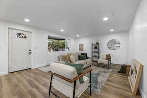 Living room featuring recessed lighting, wood finished floors, and baseboards