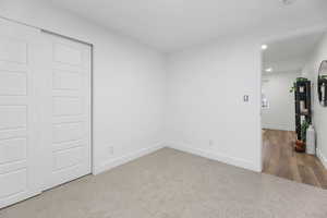 Unfurnished room with recessed lighting, baseboards, and wood finished floors