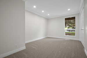 Empty room with crown molding, recessed lighting, carpet, and baseboards