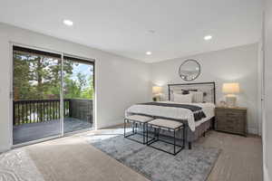 Carpeted bedroom featuring access to outside, baseboards, and recessed lighting