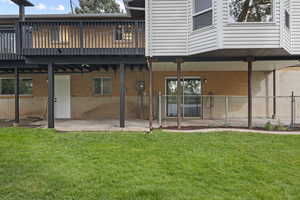 Back of house with brick siding, a patio area, and a deck