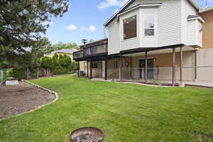 Back of property featuring a deck, central air condition unit, brick siding, and a patio