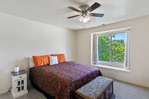 Carpeted bedroom featuring baseboards and ceiling fan
