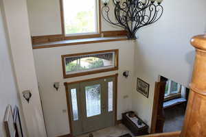 Foyer entrance with a chandelier and a high ceiling