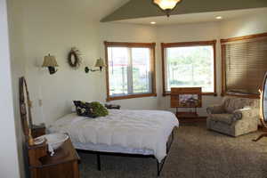 Bedroom featuring carpet floors, recessed lighting, and lofted ceiling
