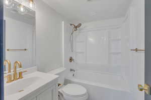 Full bathroom featuring vanity, toilet, and shower / bath combination