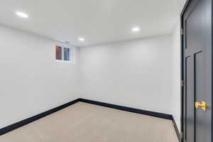 Below grade area with carpet floors, baseboards, and recessed lighting
