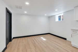 Spare room with light wood-style flooring, recessed lighting, and baseboards