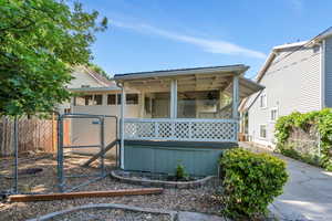 Back of property with a gate