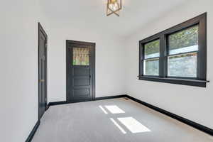 Carpeted empty room featuring baseboards