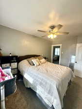 Master. Carpeted bedroom with a ceiling fan
