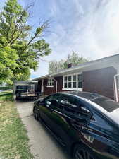 Ranch-style house with brick siding and a chimney