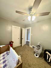 Bedroom featuring carpet, ceiling fan, and baseboards