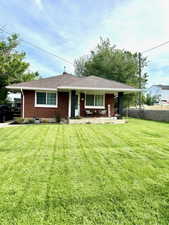 View of front of home featuring brick siding and a porch