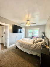 Master Bedroom with carpet floors, ceiling fan, baseboards, and a textured ceiling
