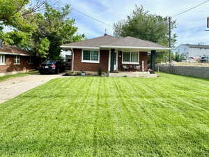 Ranch-style house featuring brick and concrete driveway