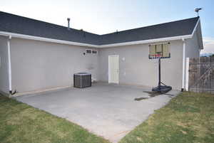 Rear view of house featuring cooling unit, and a patio