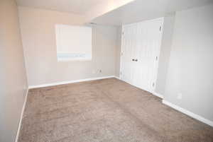 Bedroom #4 with carpet, baseboards, and a closet