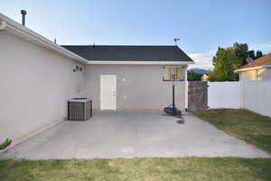 View of patio featuring central air condition unit, door to garage and side access gate