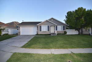 Ranch-style house featuring an attached garage, driveway, and stucco siding