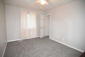 Bedroom #3 Carpeted empty room with a ceiling fan and baseboards