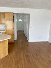 Corridor with baseboards and dark wood-style flooring