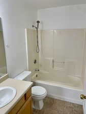 Bathroom featuring vanity, shower / washtub combination, and toilet