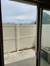 Fenced backyard featuring a patio, a mountain view, and central AC