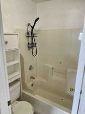 Bathroom with toilet and shower / tub combination