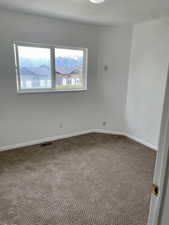 Spare room with carpet flooring and baseboards