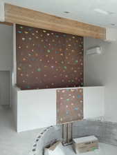 Interior space featuring concrete floors and wallpapered walls