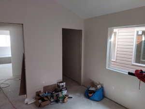 Spare room with vaulted ceiling